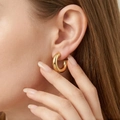 Close-up of a model wearing a thick 14K gold-plated C-shaped stainless steel hoop earring - Wire Diameter 5mm, Outer Diameter 20mm / Gold