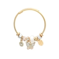 Golden twisted bangle with butterfly charms and pink enamel beads on white background - White