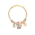 Close-up of gold wire bracelet featuring pink glass beads and a pavé butterfly charm - Pink