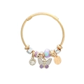 Detailed shot of golden wire bracelet featuring purple butterfly charms and crystal beads - Purple