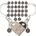 Close-up of interlocking heart-shaped building block keychains with custom letter charms - A Black And White Set (message Cards)