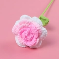 Handmade crochet rose with pink and white yarn petals on a soft pink background - Reverse Curl - Creamy Rose Stem - Gradient Glitter
