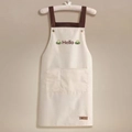 Waterproof cream kitchen apron with Hello embroidery and adjustable brown cross straps - Hello White (Standard Style)