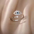Silver evil eye open ring with blue and black gems on champagne satin background - Evil Eye Style (JZ36) / Silver
