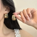 Close-up of triple-layered golden C-shaped hoop earrings in a minimalist style - 25mm / Geometric Ear Buckle (PJER228) / Gold