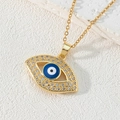 Macro shot of gold-plated evil eye pendant necklace with pavé-set crystals and blue enamel - Style R-Gold Eye Frame Micro-pave Zirconia