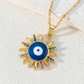 Macro shot of evil eye sun pendant necklace with colorful zircons on white stone base - Style Q-Evil Eye Sun Pendant
