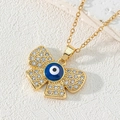 Macro view of gold-plated butterfly pendant with blue evil eye and sparkling zircon stones - Style T-Butterfly Shaped Evil Eye