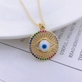 Golden Evil Eye necklace with rainbow stones and blue zircon pendant on a book - Style U-Rainbow Pave Hollow Ring Eye