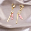 Detail of elegant gold geometric clip-on earrings with marble resin on silk fabric - Gold Pink Marble Clip On