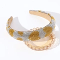 Macro view of crystal rhinestones with gold heart pattern on padded headband - White Yellow Heart