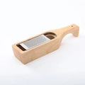 Macro shot of stainless steel cheese grater with acacia wood storage base and handle - Rubber Wood Square With-handle Style