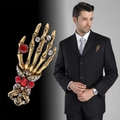 Gothic skull hand brooch in vintage gold with red crystals on black formal suit - Antique Gold Hand Bone