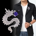 Elegant silver dragon suit brooch with white crystals and a vibrant blue center stone - Silver Dragon Blue Sapphire
