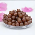 Macro shot of polished caramel nephrite jade beads for DIY bracelet making and jewelry - Wada Tamato Color / 8mm