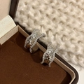 Modern wavy silver-toned hoop earrings with hammered metal texture and pave zircon edges - Silver Wavy Hammered Zirconia Style (E002557)