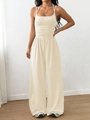 Detail of waist pleats on off-white halter neck jumpsuit with high waist wide-leg design - Apricot