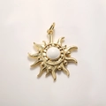 Detailed close-up of a gold-plated sun pendant featuring a central mother-of-pearl bead - White Enamel Sun (A879)