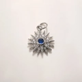 Macro view of sunburst pendant with deep blue center stone and diamond accents - Platinum Zirconia Sun (A884)