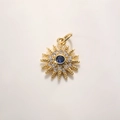 Detail of 18K gold starburst pendant with blue center stone and pave crystals - Gold Zirconia Sun (A885)