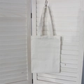 Close-up of a white canvas tote bag hanging against a wooden shutter backdrop - 8oz / White