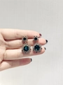 Retro snowflake drop earrings with dark green gemstone and silver rhinestone setting - Sparkling Green Zirconia