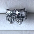 Macro detail of gothic joker ring featuring dual smile and cry mask design in retro silver - Adjustable Open / Silver