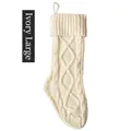 Detail of ivory white knitted Christmas stocking showing cable stitch pattern and loop - Ivory