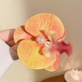 Vibrant orange butterfly orchid hair clip with realistic spots and a large faux pearl - Dark Orange