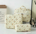 Three-piece set of quilted floral cotton cosmetic bags in cream with blue and orange prints - Yellow Base Orange Flower