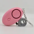 Pink egg-shaped personal safety alarm with metal keychain and gray woven wrist strap - Pink