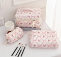 Quilted floral cotton toiletry bag set with pink roses and ribbon zippers on white surface - Pink Rose