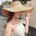 Women's wide brim straw beach hat in beige color with a wavy sun protection design - One Size / Khaki