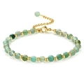 Macro detail of green beaded bracelet with polished gold spacers and lobster clasp - Green