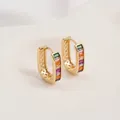 Macro detail of 14K gold huggie earrings with rainbow zircon stones and inner hollow grid - Colorful Zirconia U-Shape Huggie (15x19mm)