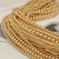 Close-up of champagne gold round pearls with glossy finish for DIY jewelry crafts - Champagne (no. 21) / Approximately 200 Pieces Per Strip 4mm In Size.