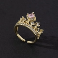 Detail of golden crown ring with square pink gemstone and sparkling zircon accents - Style 15