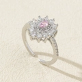Detail of silver adjustable ring with pink pear-cut zircon and floral halo design - Style 24