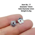 Macro shot of 10mm retro silver flower bead spacer with 2mm hole for DIY jewelry - Style 17