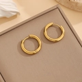 Detailed view of polished gold round hoop earrings on a textured display box - Geometric Hoop Earrings Gold (E083)