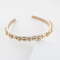 Detail of white satin headband featuring hand-sewn rectangular and round crystals - White