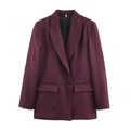 Detail of burgundy blazer showing notched lapels, two buttons, and flap pockets on front - Dark Red