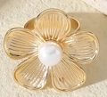 Detailed macro of golden metal flower napkin ring with a white pearl center - Radiant Hollow Flower Pearl Style (X2319)