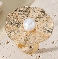 Close-up of golden flower ring with hammered texture and a central white pearl - Fashion Exaggerated Wave Pearl Style (X2321)