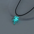 Luminous blue leaf pendant necklace with glowing effect in dark surroundings detail - Blue-Green Maple Leaf (NY956)