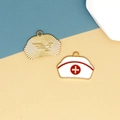 Close-up of alloy nurse cap and golden eagle charms for DIY jewelry making accessories - Nurse Hat / White