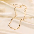 Double-layered gold snake chain necklace with small square cubes on white silk background - Double Square Necklace (H352) / Gold
