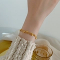 Elegant gold multi-layered bead chain bracelet styled with a white lace sleeve - Triple Strand Bead Chain Bracelet (QYE188) / Gold