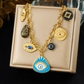 Golden Hamsa Hand and Evil Eye charm bracelet with chunky chain on a jewelry box - N4135