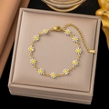 Detail of gold stainless steel daisy bracelet with white enamel petals on a jewelry box - White Daisy Bracelet (E170) / Gold